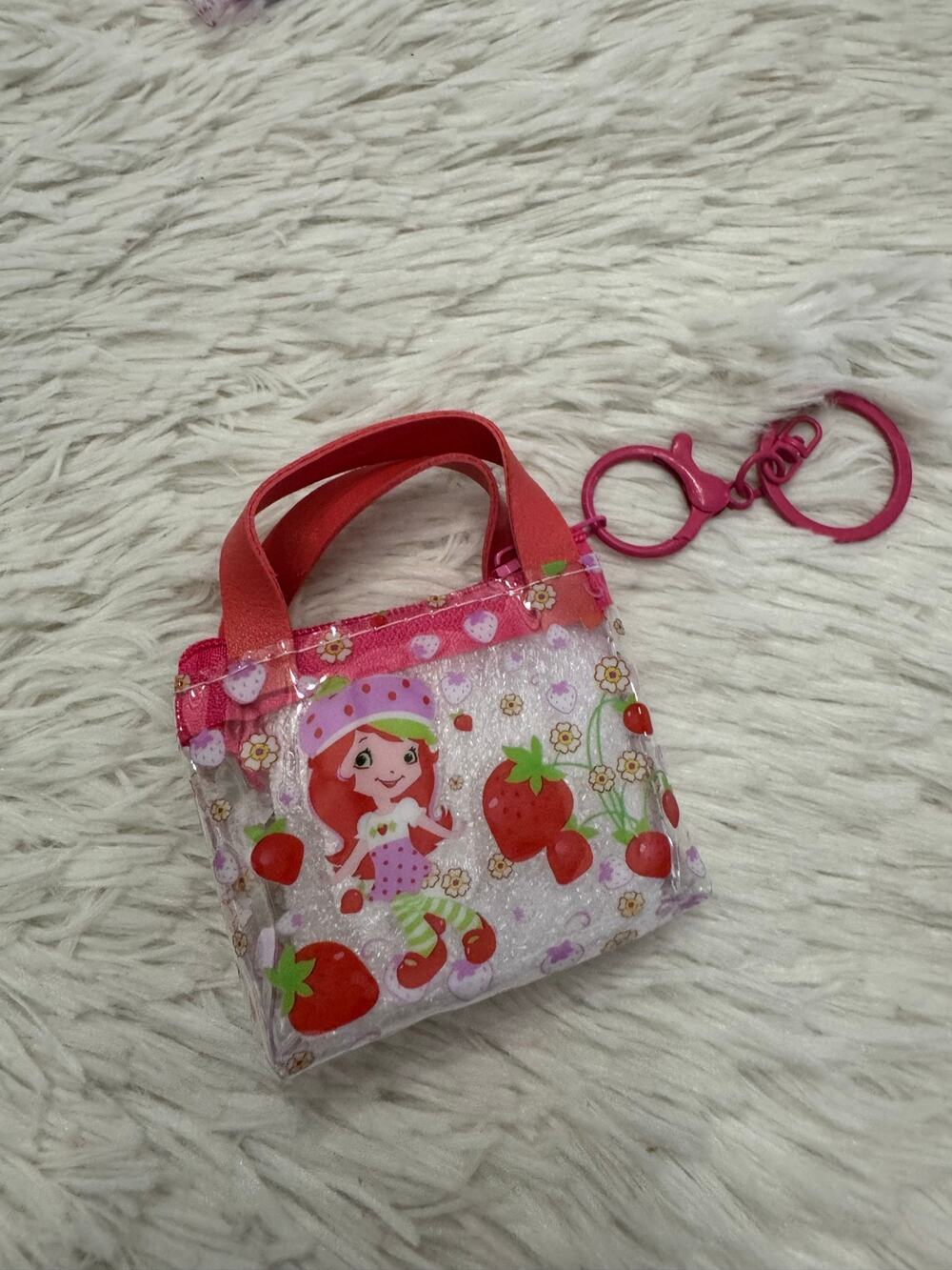 Strawberry Shortcake clear mini purse with strawberry and flower graphics